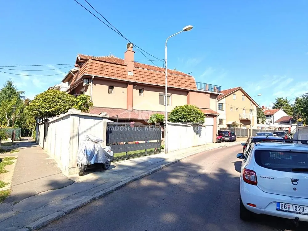 Exterior view of the house with a street and yard.