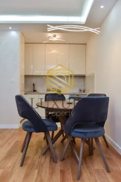 Dining area with a table and chairs within the kitchen space. - image 13