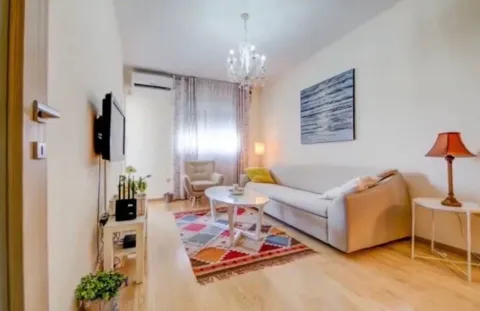 Furnished living room with sofa and TV. - image 2