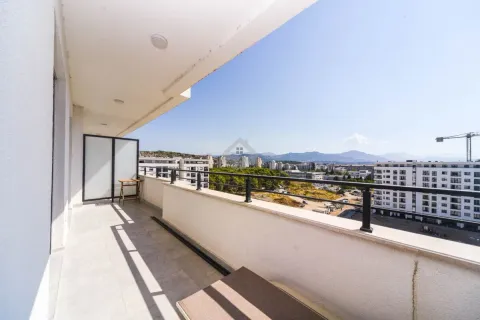 Spacious balcony with a view of the city and surrounding buildings. - image 10
