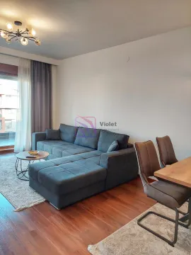 Living room with a sofa and dining area. - image 2