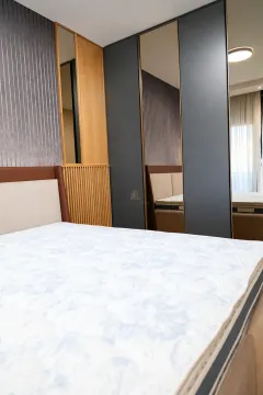 Modern bedroom with a double bed and fitted mirrored wardrobes. - image 12