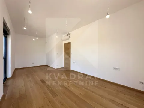 Empty room with wooden flooring and ceiling lights. - image 7