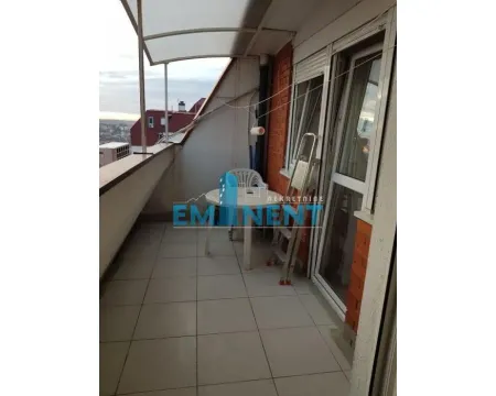 Covered balcony with a table, chairs, and a view of the surroundings. - image 14