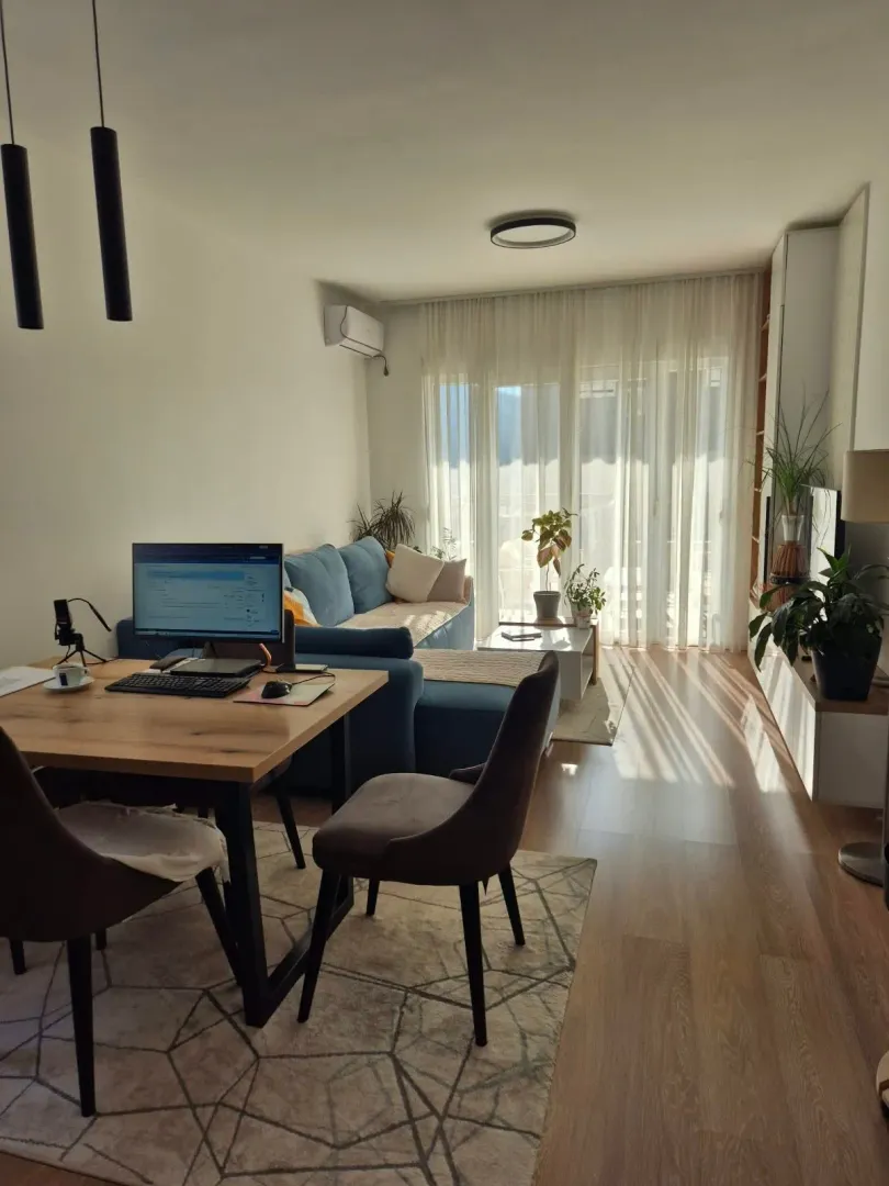 Bright living room with a dining area and a sofa.