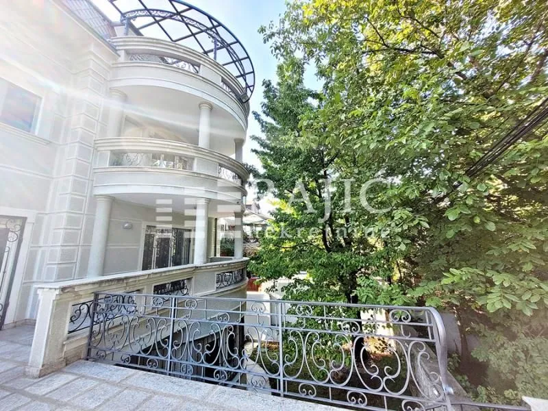 Exterior of a multi-family building with balconies and a yard.