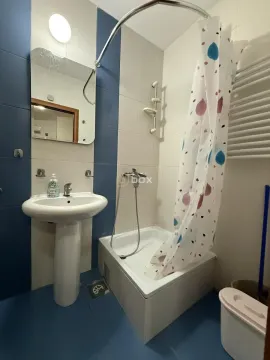 Bathroom equipped with a washbasin, mirror, and a shower with a curtain. - image 2