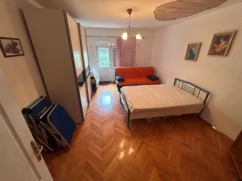 Furnished bedroom with a double bed, wardrobe, and a sofa. - image 6
