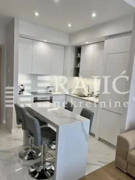 Modern white kitchen with an island and bar counter integrated with the living area. - image 7