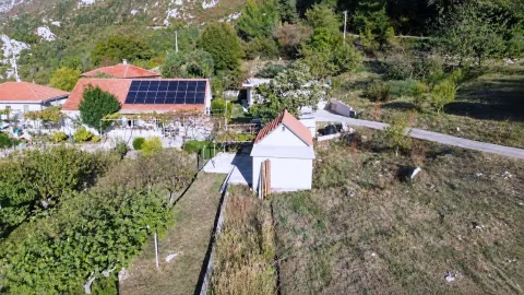 Aerial view of the property with a house, solar panels, and yard. - image 12