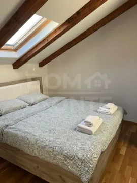 Attic bedroom with a double bed and a roof window. - image 5