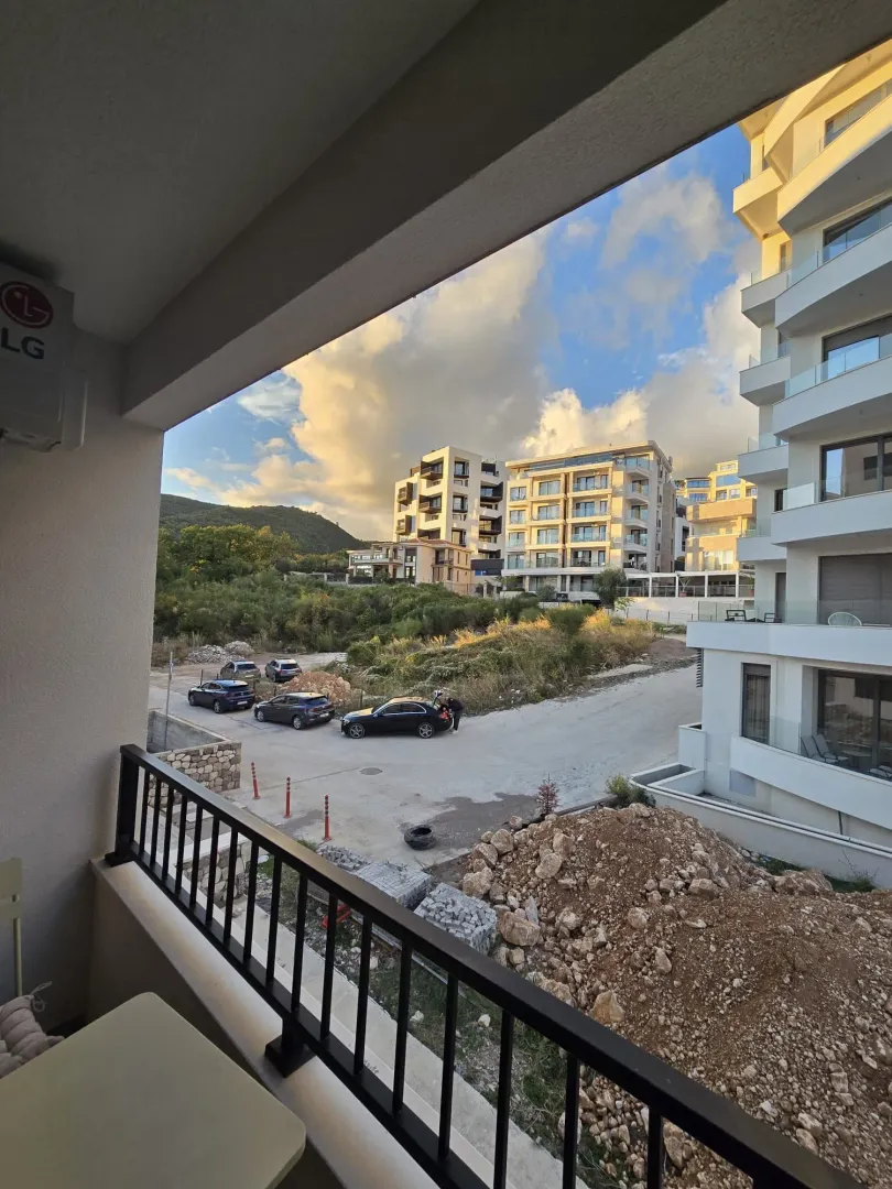 View from the balcony overlooking surrounding buildings and nature.