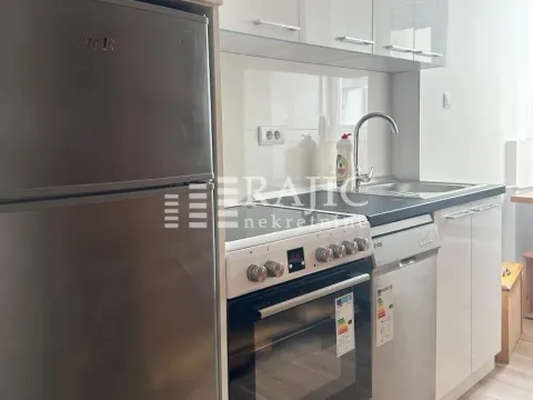 Modern white kitchen with a refrigerator and built-in appliances. - image 5