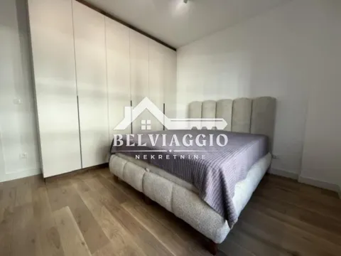 Bedroom with a double bed and a large fitted wardrobe. - image 12