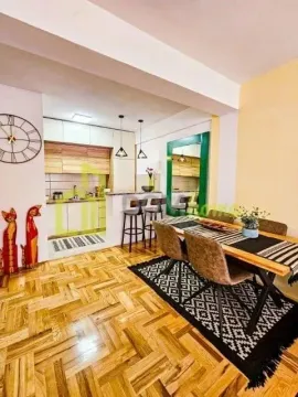 Living room with dining area and open-plan kitchen. - image 3