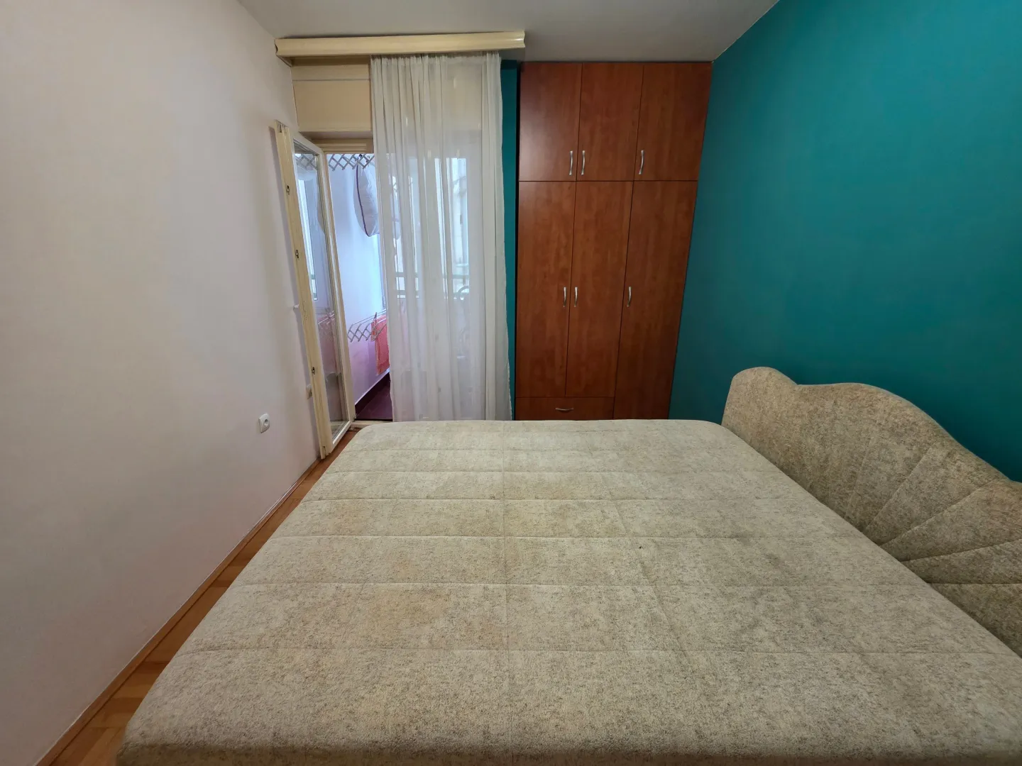 Bedroom with a double bed, wardrobe, and access to the terrace.