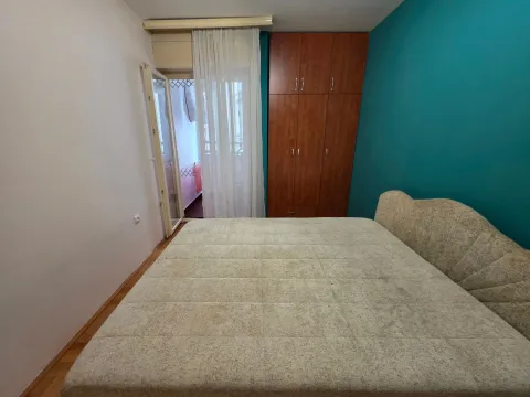 Bedroom with a double bed, wardrobe, and access to the terrace. - image 8