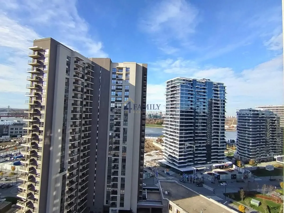 View from the terrace overlooking modern apartment buildings and the urban surroundings.