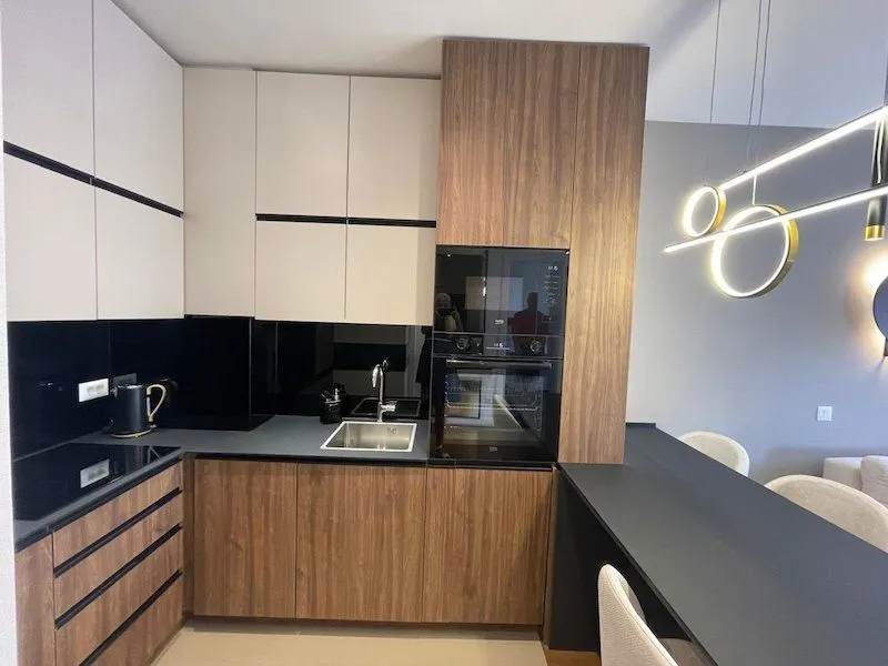 Modern kitchen with built-in appliances and a dining bar.