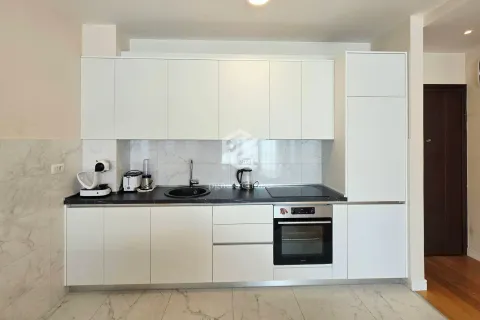 Modern kitchen with white cabinets and a black countertop. - image 8