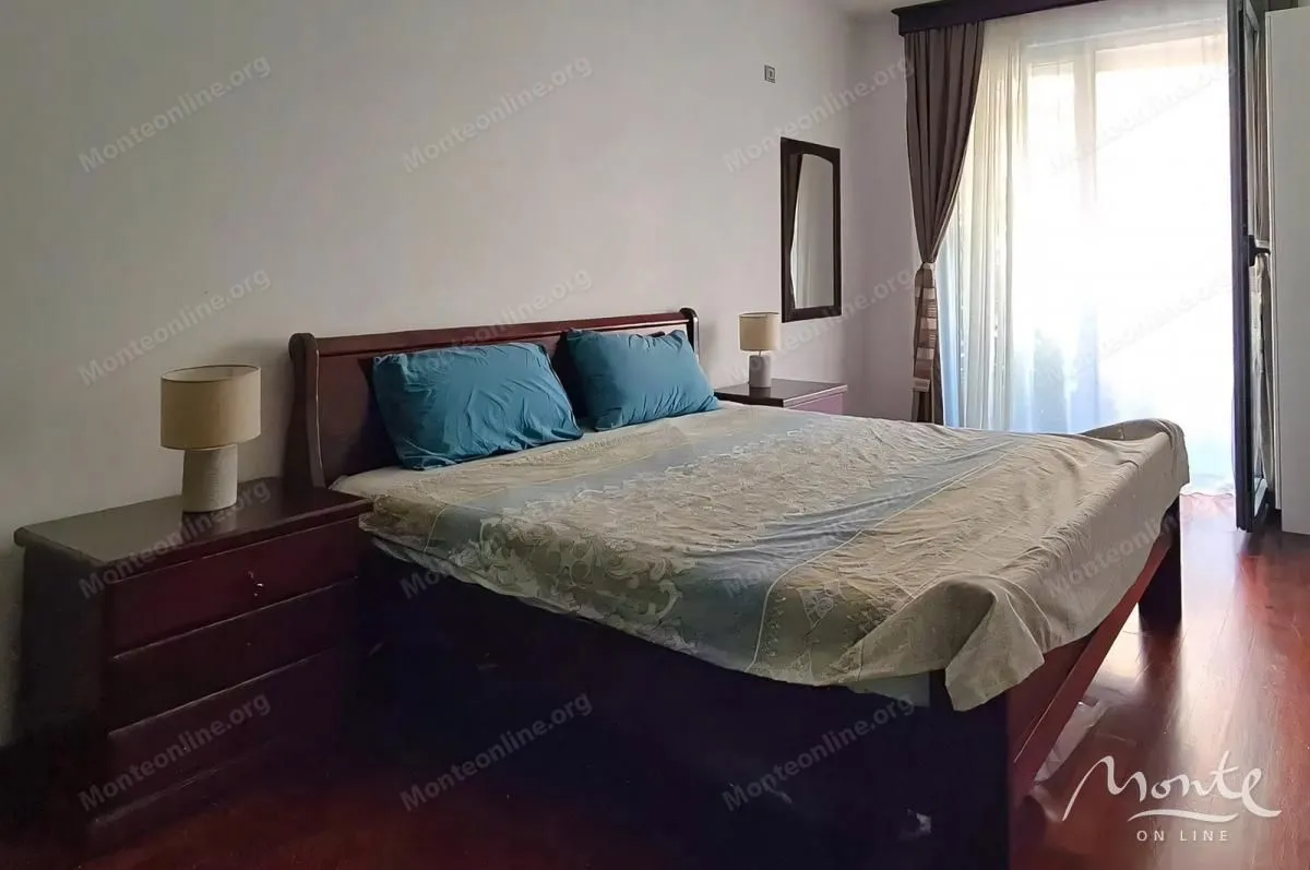 Furnished bedroom with a double bed, bedside tables, and access to the terrace.