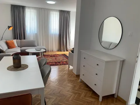 Bright and modernly decorated living room with a dining table. - image 16
