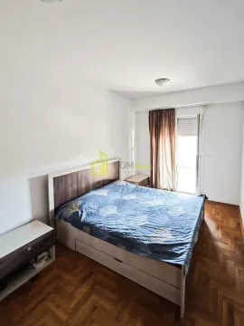 Bedroom with a double bed, wooden floor and access to the balcony. - image 6