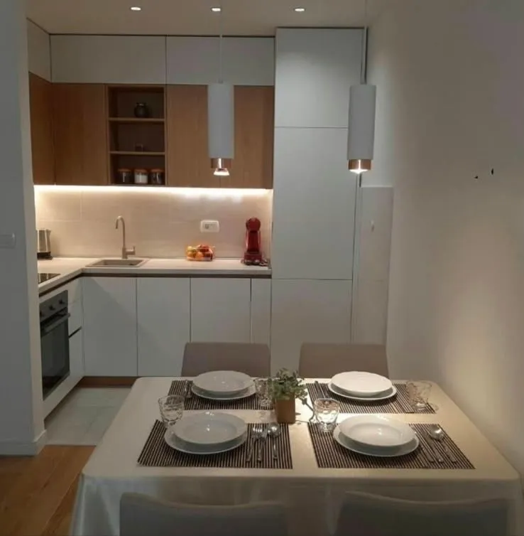 Modern kitchen with a dining area and built-in appliances.