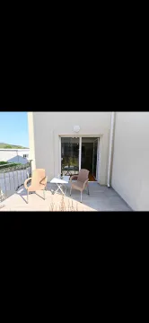 Furnished terrace with a table and chairs and a view of the surroundings. - image 12