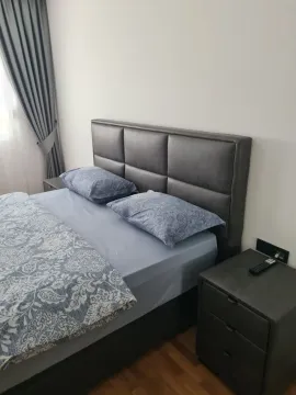 A bright bedroom featuring a modern double bed and a nightstand. - image 7