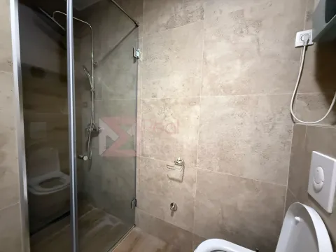 Modernly equipped bathroom with a walk-in shower. - image 11