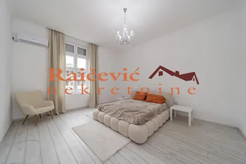 Bright bedroom with a double bed, an armchair, and a chandelier. - image 12