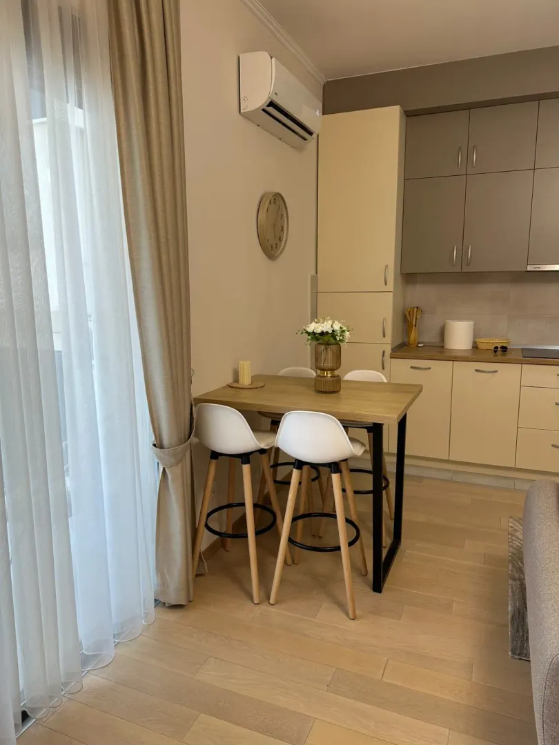 Modern kitchen with dining table and chairs.