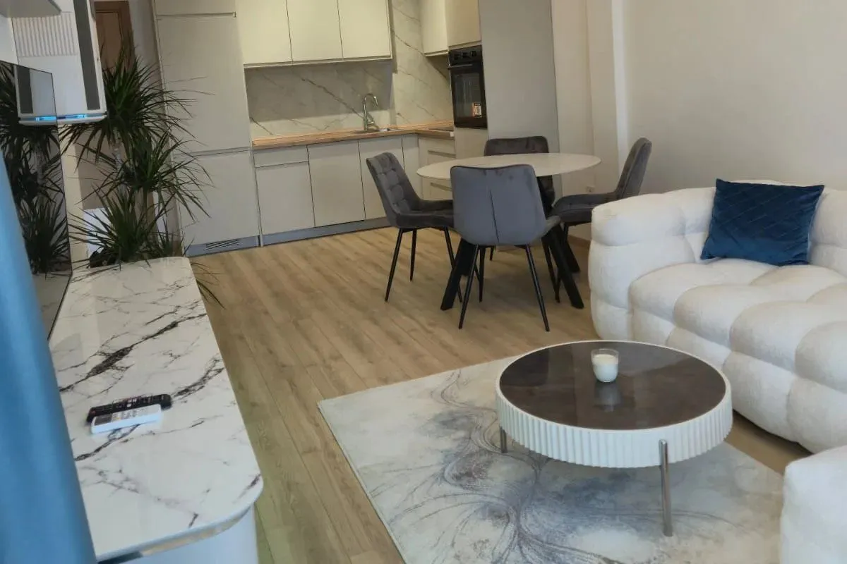 Modern living room with a sofa and dining area.