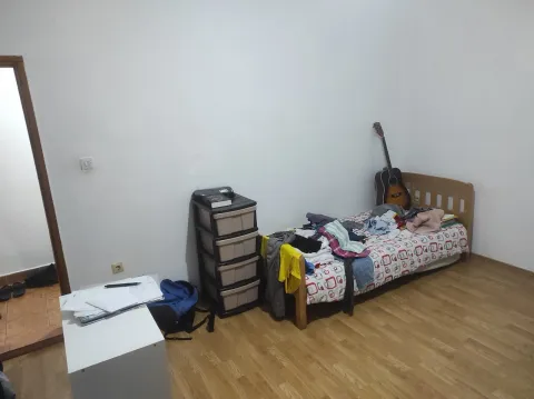 A bright bedroom with a single bed and laminate flooring. - image 4