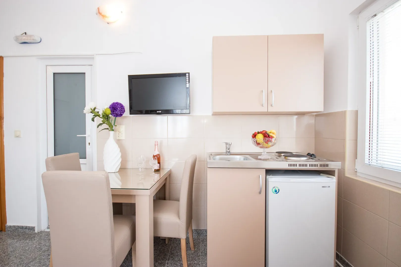Small kitchen with a dining table and chairs.