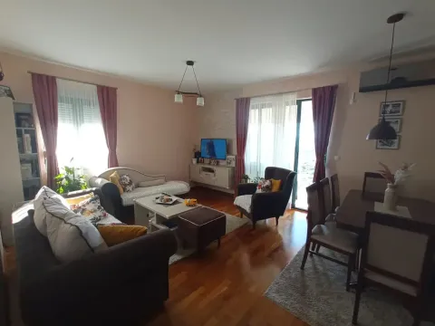 Spacious living room with a dining area, seating set, and hardwood flooring. - image 11