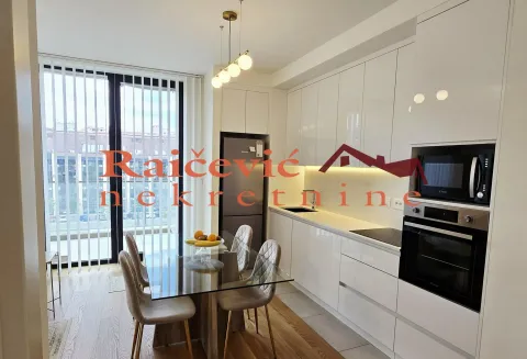 Modern kitchen with dining area and access to the terrace. - image 2