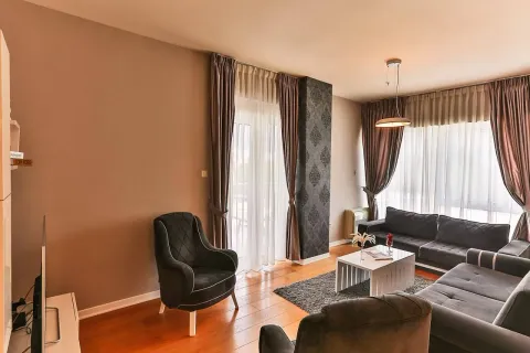 Spacious living room with seating furniture and hardwood flooring. - image 2