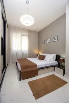 Modern bedroom with a double bed, wardrobe, and lighting. - image 5