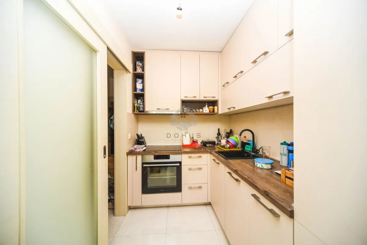 Smaller kitchen with built-in cabinetry and appliances.