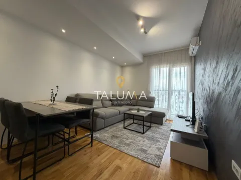 Living room with a sofa, dining table, and access to the terrace. - image 4