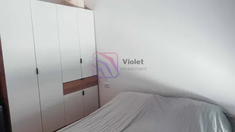 Bedroom with a bed and a white wardrobe. - image 7