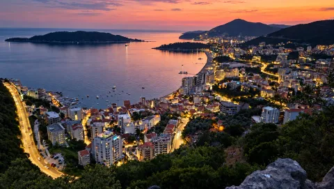 View of the city, coastline, and bay at dusk. - image 20