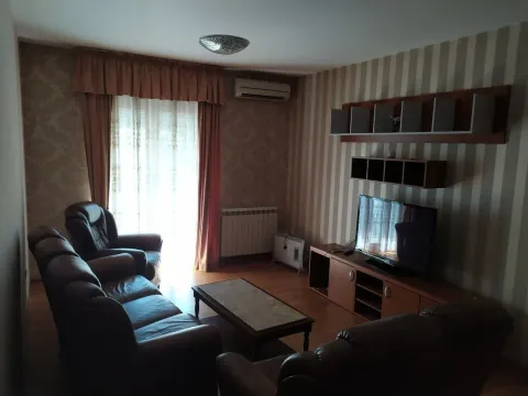 Furnished living room with leather sofas, a TV, and a coffee table. - image 2