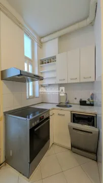Small white kitchen with a stove, sink, and dishwasher. - image 13