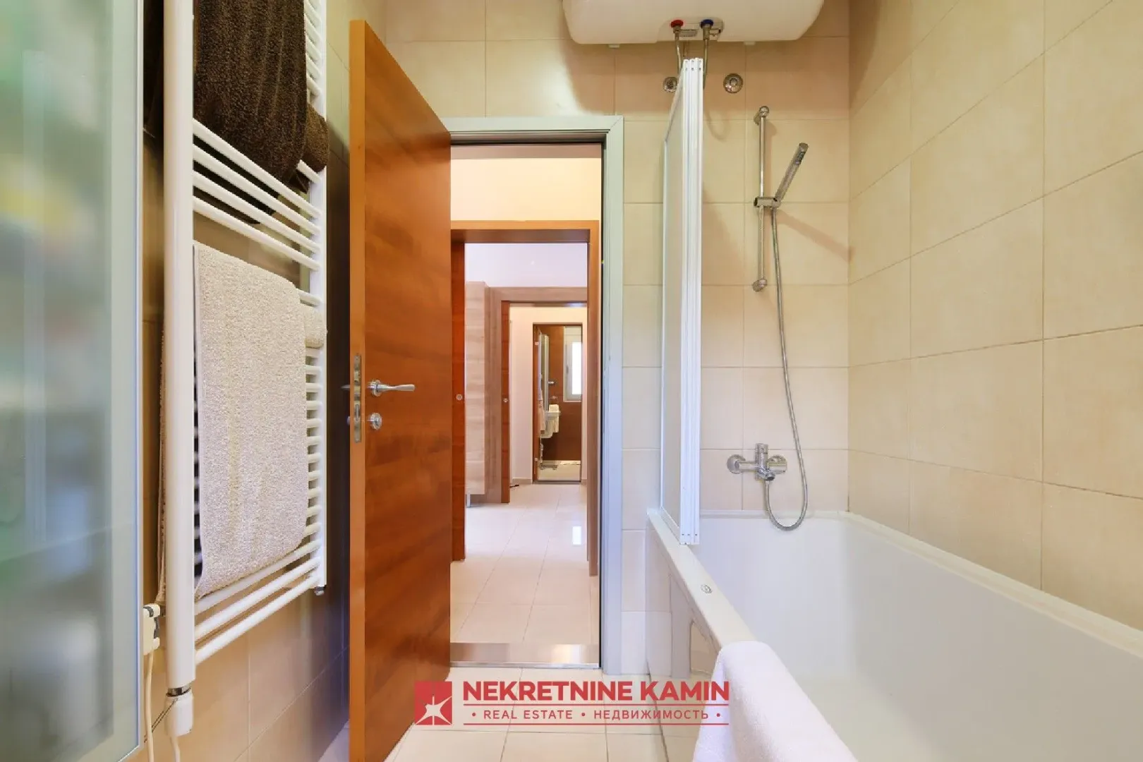 Bathroom with bathtub and towel radiator.
