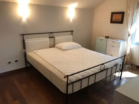 Bedroom with a double bed, wooden flooring, and a dresser. - image 7