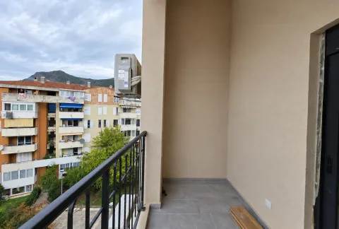 Unfurnished balcony with a view of neighboring buildings and hills. - image 17