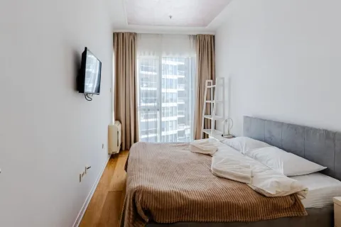 A bedroom with a double bed, television, and access to the terrace. - image 9